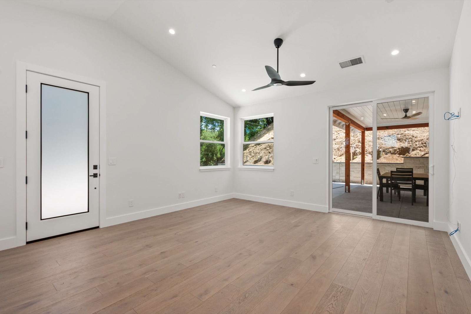 ADU interior with vaulted ceiling and wide-plank oak floors