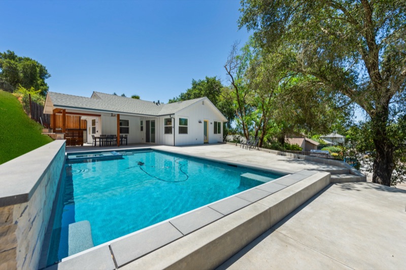 ADU and pool with surrounding site work and patios
