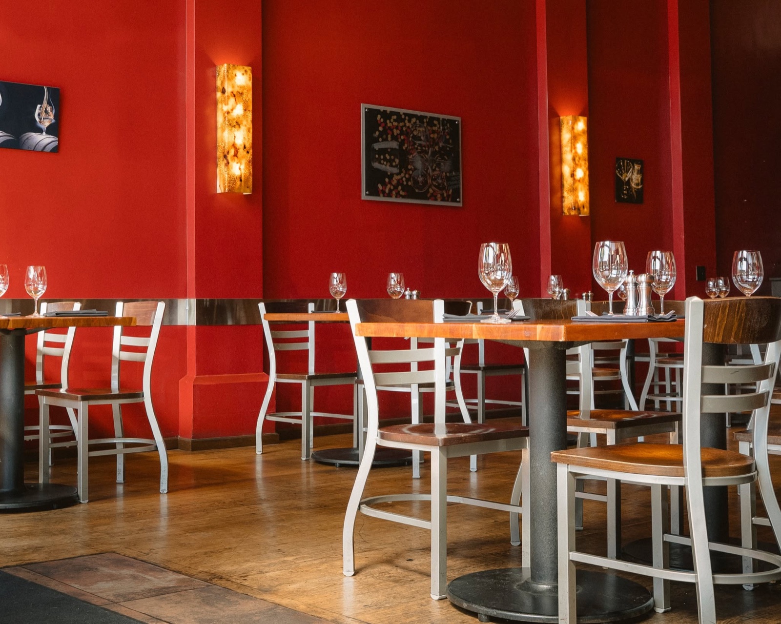 Dining room with red walls and wood-topped tables at Jackson's Bar & Oven