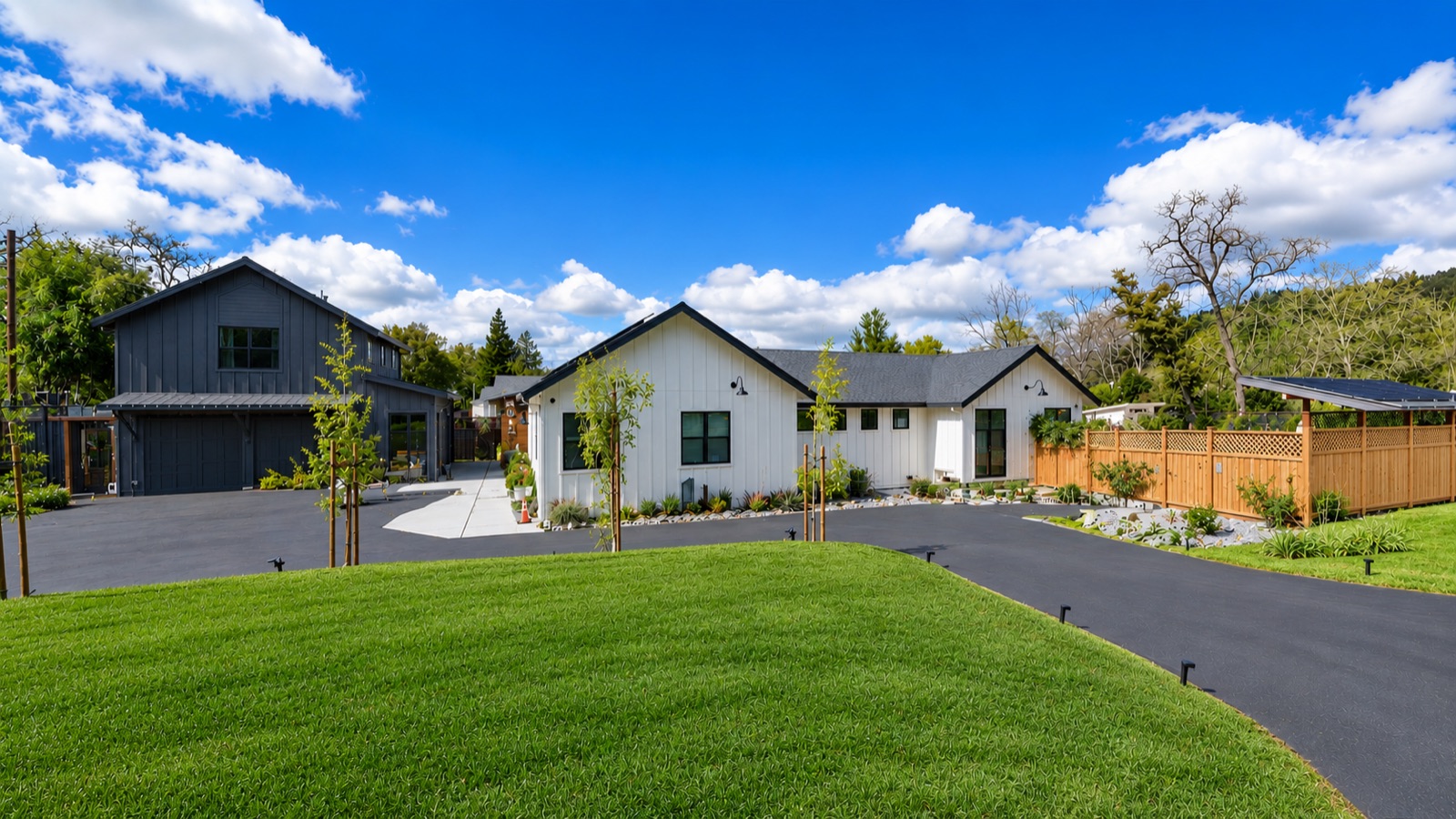 Modern farmhouse home with detached garage after fire rebuild